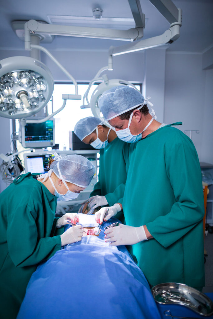 Surgeons performing operation in operation theater of hospital